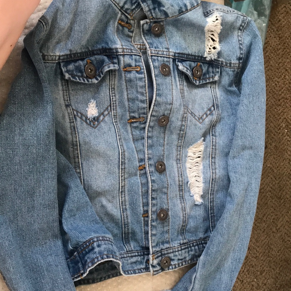jean jacket with some rips